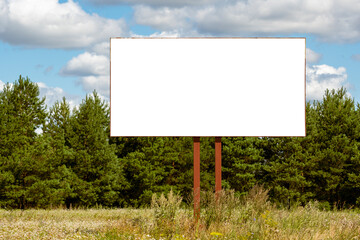 A blank advertising billboard in a grass field