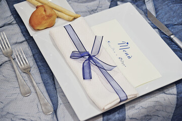 Detail of a table set in blue for a wedding banquet