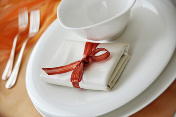 Table set in orange organza for a wedding banquet