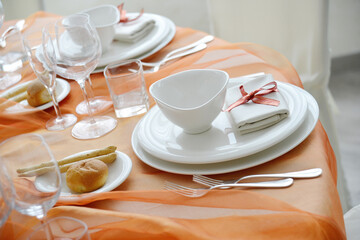 Table set in orange organza for a wedding banquet
