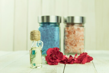 A bottle of aromatic oil and jars of aromatic spa salt