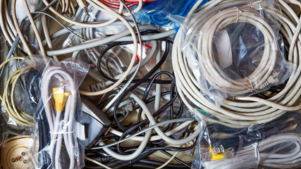 Messy drawer full of wired and cables - 520176568