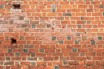 Red brick wall made of stone, close-up