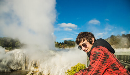 people in geothermal volcanic park with geysers and hot streams, scenic landscape, te piua national...
