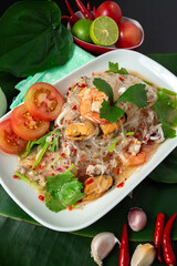 Top view of seafood vermicelli salad with squid, shrimp, clams, minced pork, Thai street food, Thailand