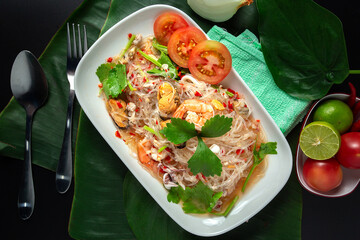 Top view of seafood vermicelli salad with squid, shrimp, clams, minced pork, Thai street food, Thailand