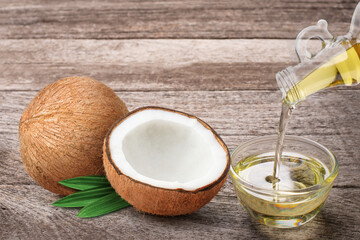 Coconut fruit and coconut oil isolated on wood table background. 
