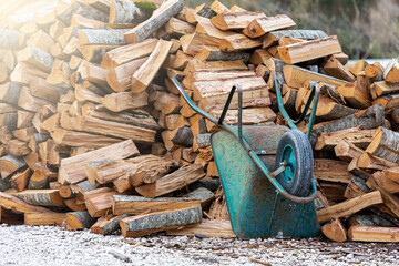 Wheelbarrow for transportation near a pile of firewood