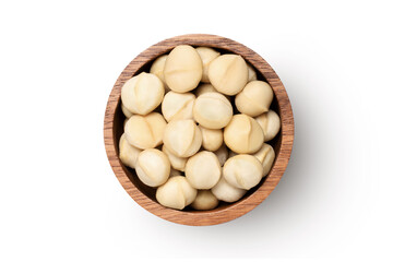 Macadamia nuts in wooden bowl isolated on white background, top view, flat lay.