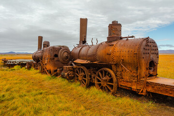 Last train to nowhere; rusty wreck of a locomotive on the tundra in autumn colors, Nome Alaska