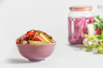 Various pickled vegetables in bowl at white background with jars. Healthy homemade preserved food....