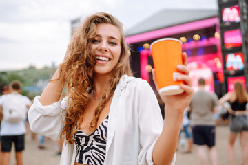 Happy woman with beer at music festival. Beach party, summer holiday.