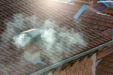 Smoke from the chimney. Furnace heating during the energy crisis