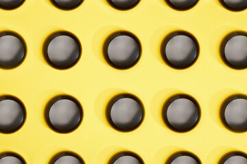View from the top on many black ring case isolated on yellow background.