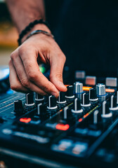 DJ Hands creating and regulating music on dj console mixer in concert outdoor - obrazy, fototapety, plakaty
