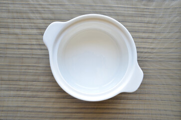 empty white plate on wooden table