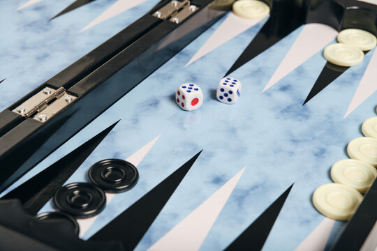 Board with cubes and chips for playing backgammon.