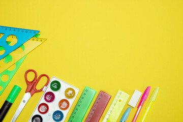 school stationery on yellow background with copy space