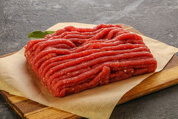 Raw beef minced meat over board