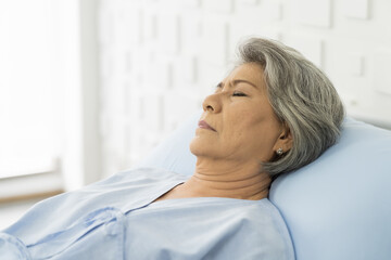 Elderly asian woman sleeping on bed at hospital ward. medicine, health care, old people and...