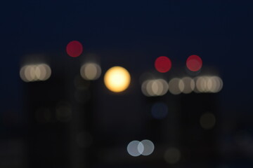 Defocused lens flare lights in the city glowing in the dark