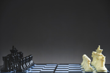 Black and white chess pieces on chessboard.