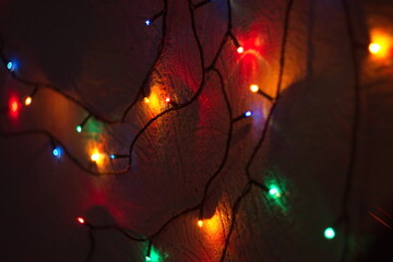 christmas garlands of lights on the wall in the house dark background overlay