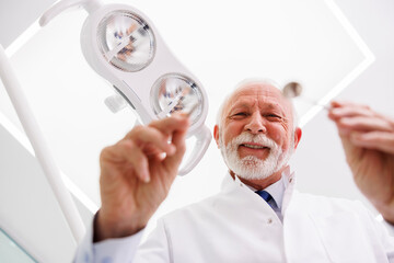 Dentist checking up patient at dental clinic