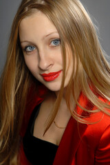Fototapeta premium beautiful woman with red lipstick and long blond hair in studio