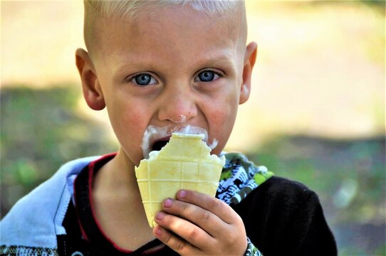 portrait of a cute boy eating ice cream