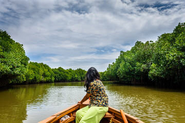 Young Indian woman boating through Pichavaram Mangrove Forests. The second largest Mangrove forest in the world, located near Chidambaram in Cuddalore District, Tamil Nadu, India