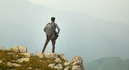 Photographer with backpack and digital camera in nature. Travel. Active lifestyle