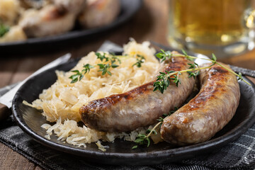 Grilled bratwurst and sauerkraut meal - obrazy, fototapety, plakaty