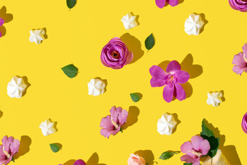 Exotic pink flowers, creative pattern on bright yellow background. Summer holidays layout.