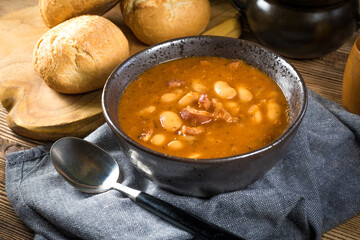 Beans with tomato sauce, bacon and sausage.