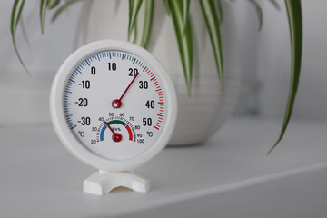 Round mechanical hygrometer on white table indoors. Space for text - obrazy, fototapety, plakaty