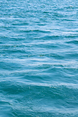 Sea surface. Turquoise sea water. Close up blue water surface at deep ocean