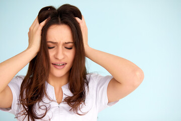 Fototapeta premium Headache And Stress. Beautiful Young Woman Feeling Strong Head Pain. Portrait Of Tired Stressed Female Suffering From Painful Migraine, Holding Hands Near Face. Health Care Concept. High Resolution