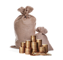Stacked coins and sack full of money on white background
