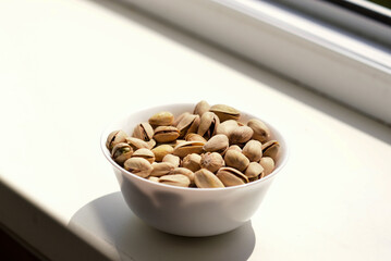 Delicious fresh pistachios in a white plate