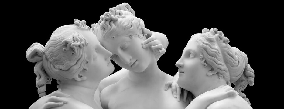 The Three Graces, Le tre Grazie. Neoclassical sculpture, in marble, of the mythological three charites isolated on black background