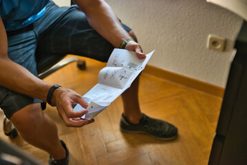 Reading instructions to assemble a furniture. Working at home. 