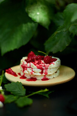 Cake with rice crisp bread and raspberry jam on a black background, outdoor garden fresh bush, sunlight. Easy food. Healthy layered dessert, Vegan, diet, organic natural birthday