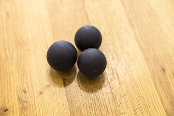 Black squash balls in squash court