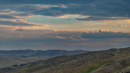 Mountains and clouds at sunset. Soft focus