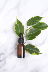 Unbranded serum bottle with leaves on marble background. Hyaluronic acid oil, serum with collagen...