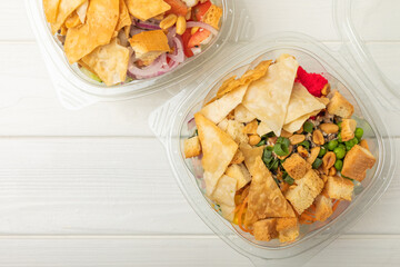 Poke from salmon, funchose, vegetables and pita crispy on a white wooden background.Healthy healthy food.Hawaiian food. View from above. Place to copy.