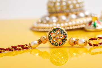 Indian festival: Raksha Bandhan. A traditional Indian wrist band on yellow background.