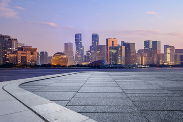 Empty floor and modern city skyline with building at sunrise in Hangzhou, China. 