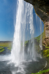 The waterfall Seljalandsfoss in southern Iceland seen from behind